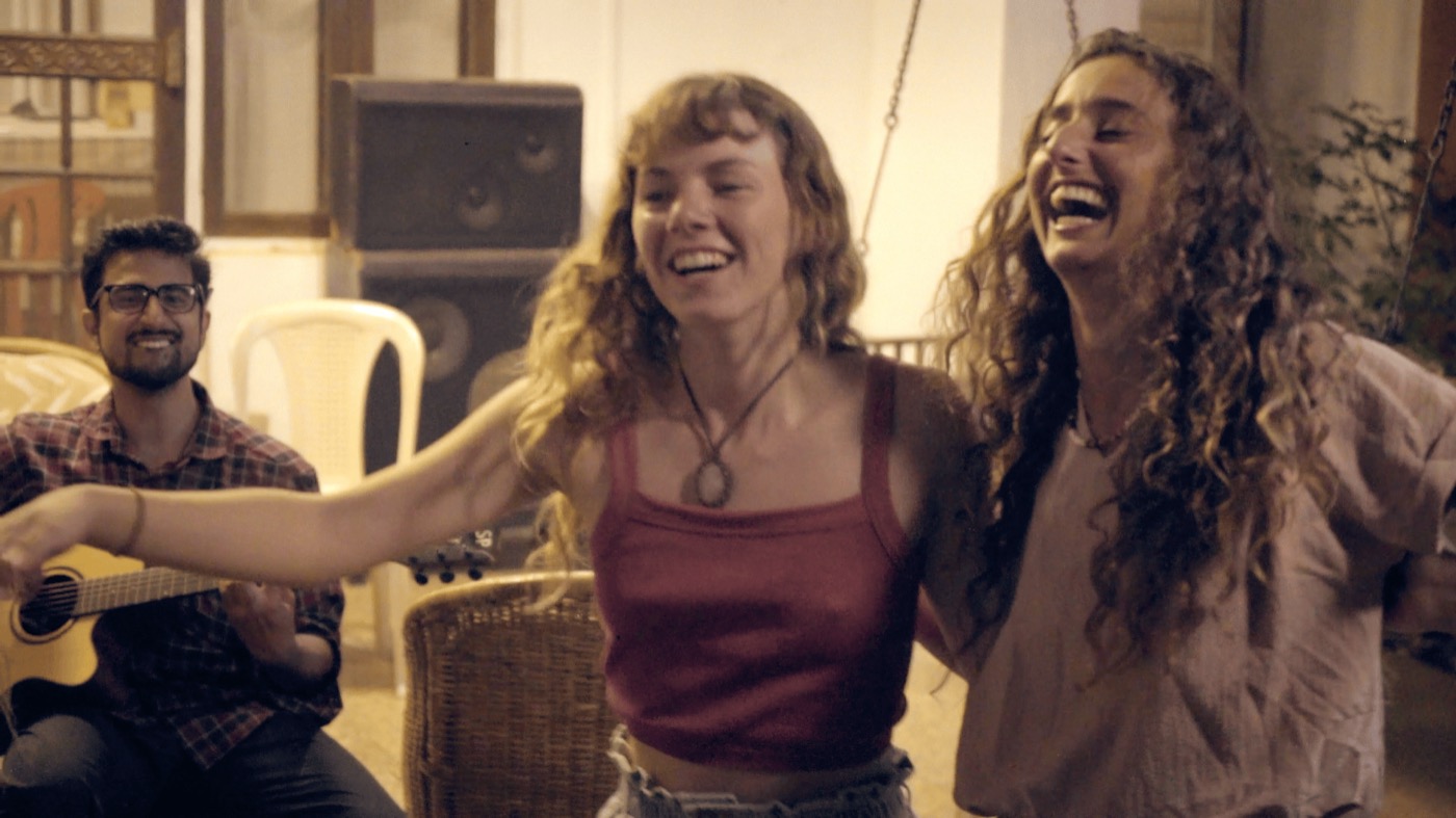 Residents laughing and playing guitar in the evening